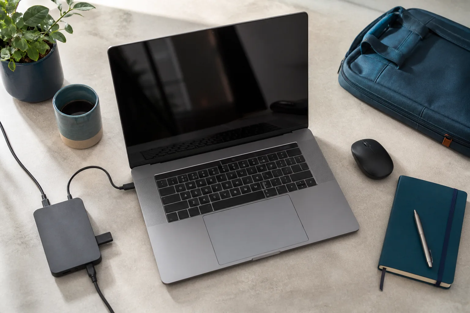 Laptop, USB-C dock and everyday work accessories arranged on a desk